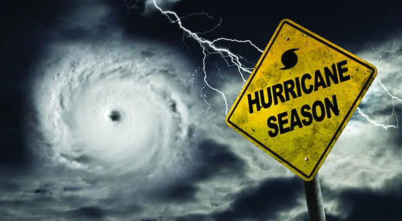 Yellow sign with words "Hurricane Season" and hurricane clouds.